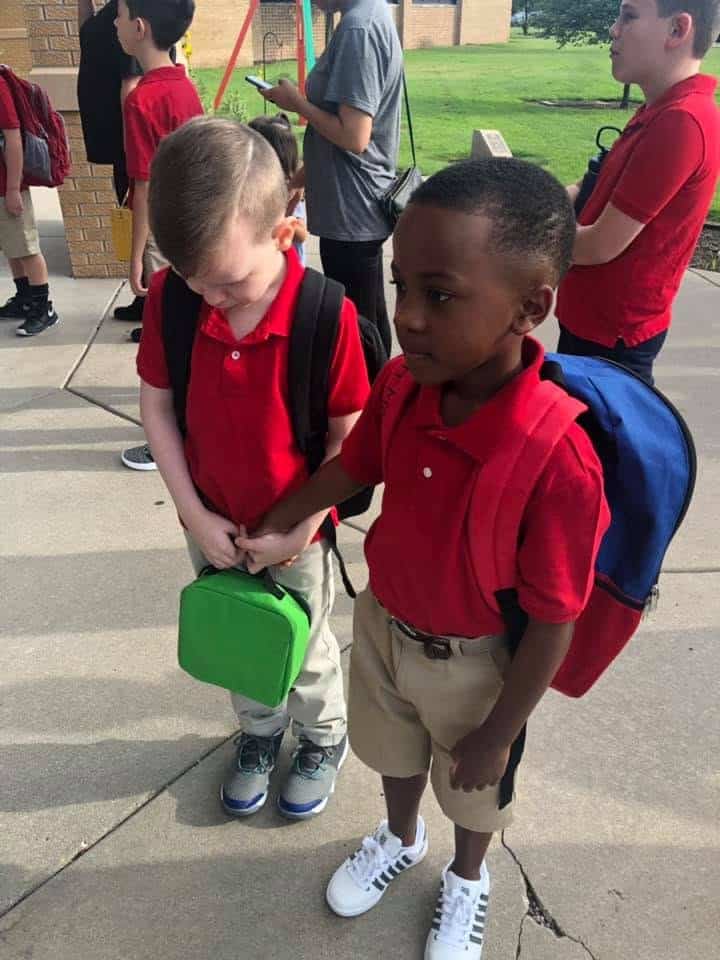 He Saw a Classmate Crying on the First Day of School. What He Did Next Melted Hearts 1 Christian Moore holds Conner's hand walking into school on the first day