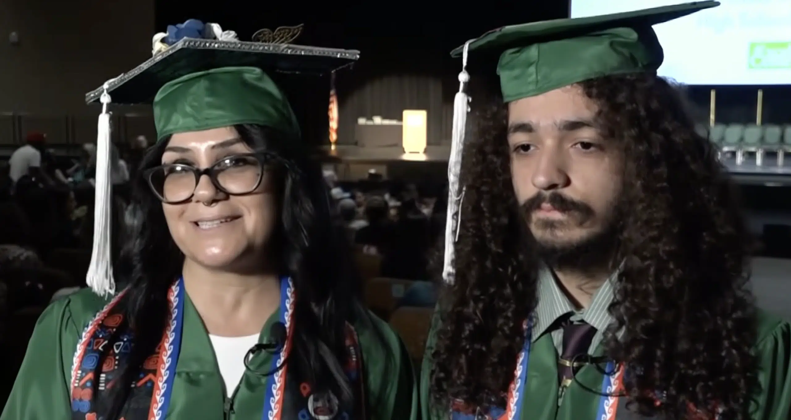 Melody and Cecil Carrizosa in graduation caps and gowns at the Excel Center ceremony