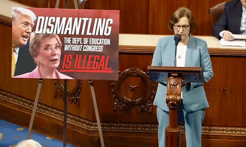 Rep. Suzanne Bonamici speaking on the House floor next to a sign reading 'Dismantling the Dept. of Education without Congress is illegal'